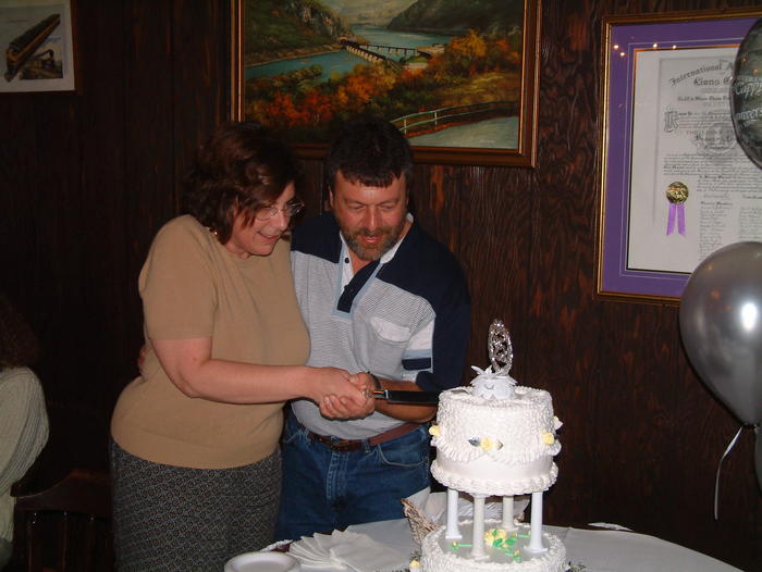 Sally and CJ cutting the cake