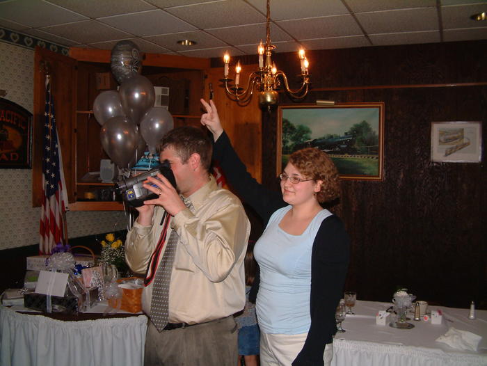 Allison gives Brian some bunny ears