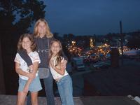 Heather with her little sisters by the carnival