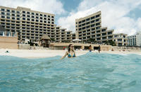 Heather in the ocean, our hotel in background