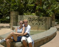 Glenn & Christina next to Rainforest Cafe sign