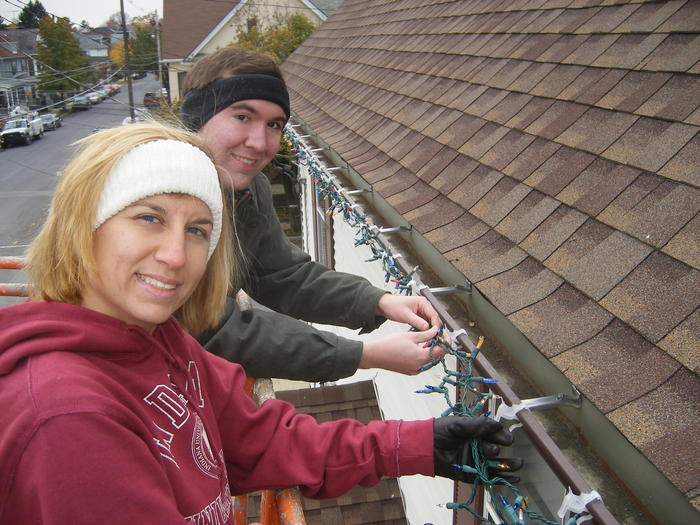 Mike & Heather putting lights on the gutters.