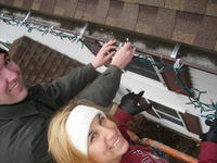 Mike & Heather putting lights on the gutters.