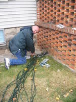 Dad pulls more cables through the porch.