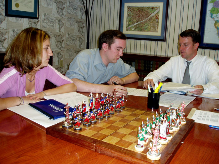 Heather, Mike, and Attorney Clint siging at closing, June 1st, 2004.