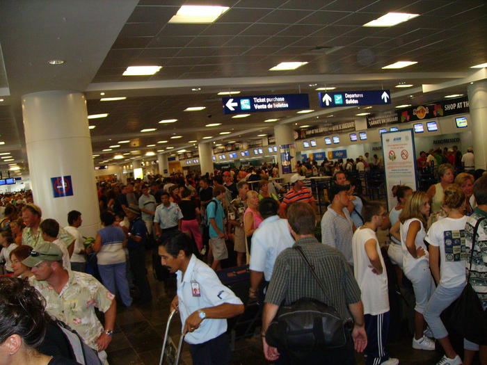People trying to get flights out before Hurricane Emily arrives.